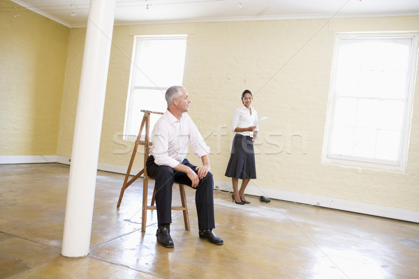 Férfi ül létra üres hely nő tart Stock fotó © monkey_business