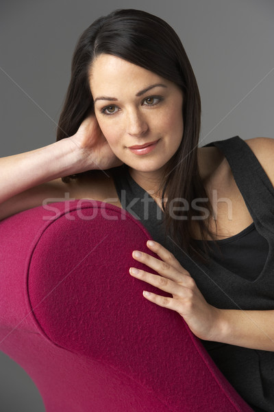 Studio Portrait Of Woman Relaxing On Pink Chaise Longue Stock photo © monkey_business