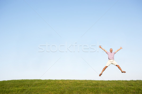 Senior man jumping in air Stock photo © monkey_business
