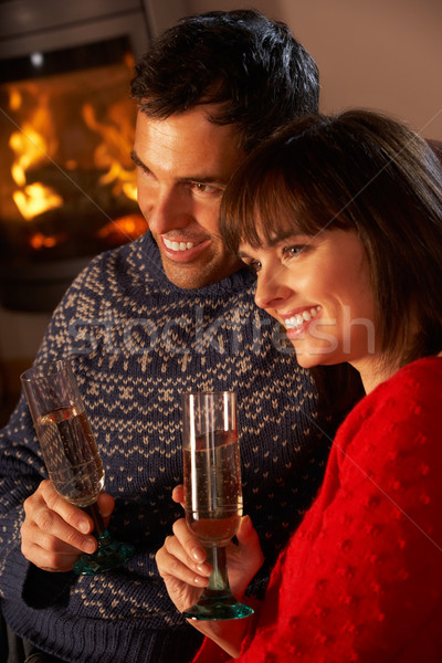 Middle Aged Couple Sitting Sofa By Cosy Log Fire With Glass Of C Stock photo © monkey_business