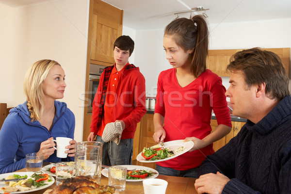 Unhelpful Teenage Clearing Up After  Family Meal In Kitchen Stock photo © monkey_business