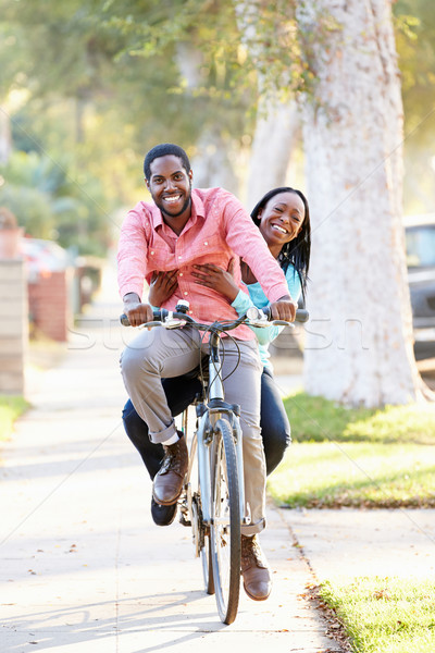 Stock photo: Couple Cycling Along Suburban Street Together