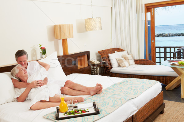 Senior Couple Relaxing In Hotel Room Wearing Robes Stock photo © monkey_business