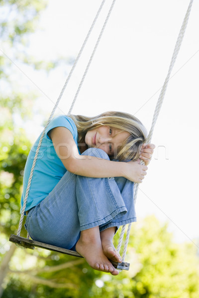 Young girl sitting on swing smiling Stock photo © monkey_business