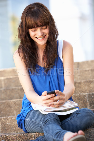 Teenage Student Sitting Outside On College Steps Using Mobile Ph Stock photo © monkey_business