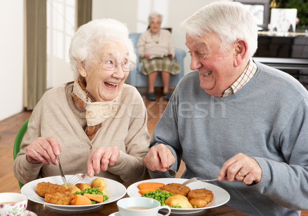 Idős pár élvezi étel együtt férfi eszik Stock fotó © monkey_business