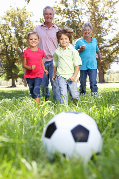 Grandparents Playing Football With Grandchilderen Stock Photo