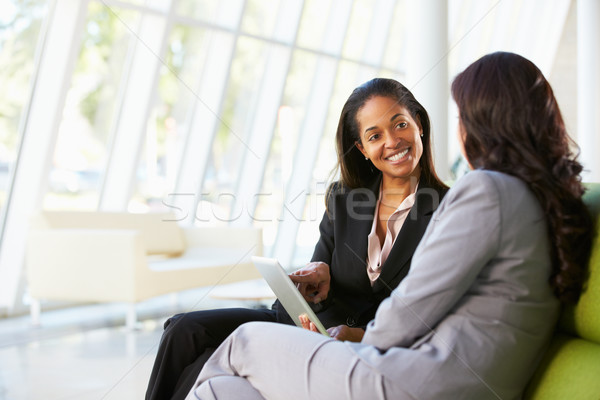 Businesswomen With Digital Tablet Sitting In Modern Office Stock photo © monkey_business