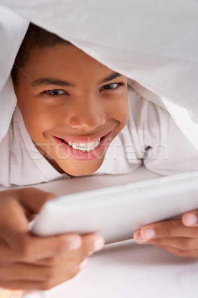 Boy Using Digital Tablet Under Duvet Stock photo © monkey_business