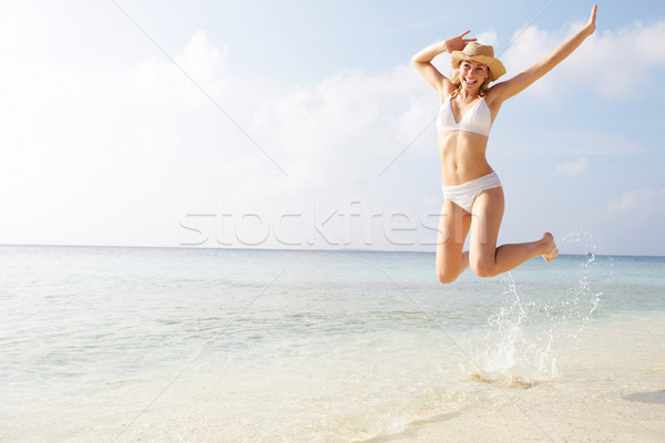 Woman Jumping In The Air On Tropical Beach Stock photo © monkey_business