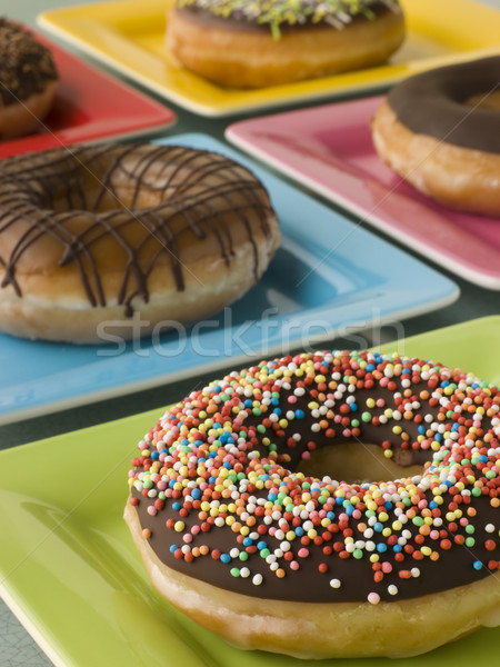 Selection Of Ring Doughnuts On A Different Coloured Plates Stock photo © monkey_business