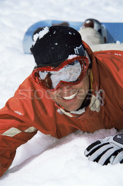 Fiatal snowbordos hó mosolyog ünnep biztosítás Stock fotó © monkey_business