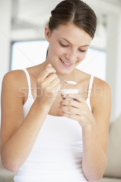 Fiatal nő eszik joghurt étel boldog mosolyog Stock fotó © monkey_business