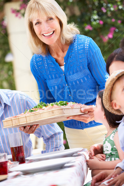 Idős nő adag többgenerációs család étel nők Stock fotó © monkey_business