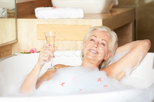 Senior Woman Relaxing In Bath Drinking Champagne Stock photo © monkey_business