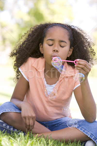 Young girl blowing bubbles outdoors Stock photo © monkey_business