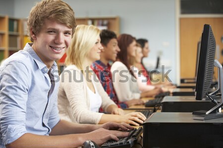 Stock photo: Schoolchildren practicing on a keyboard in music class