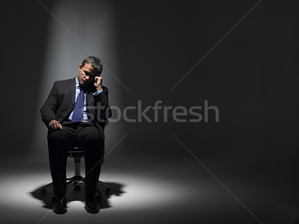 Stock photo: Businessman Sitting In Spotlight