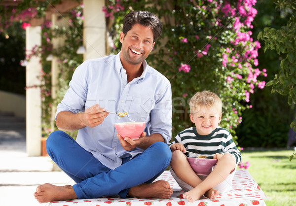 Father And Son Enjoying Breakfast Cereal Outdoors Together Stock photo © monkey_business