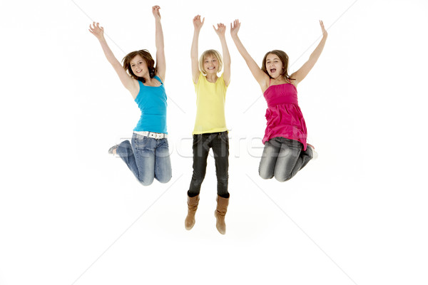 Stock photo: Group Of Three Young Girls Leaping In Air
