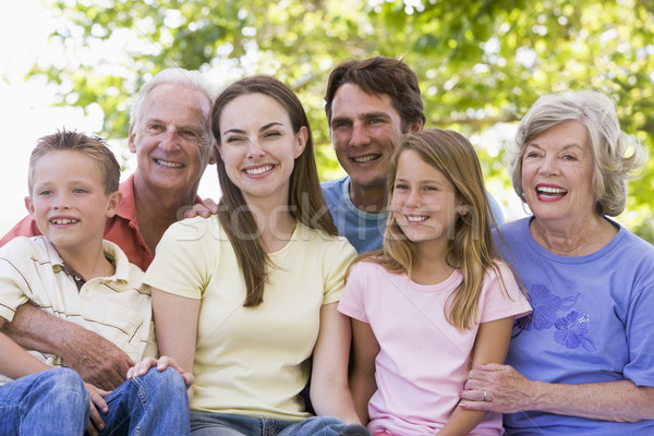 Extended family sitting outdoors smiling Stock photo © monkey_business