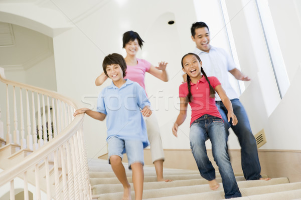 Family running down staircase smiling Stock photo © monkey_business