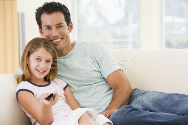 Adam genç kız oturma odası uzaktan kumanda gülen mutlu Stok fotoğraf © monkey_business