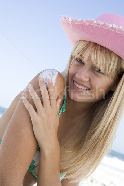 Nő jelentkezik nap elleni védelem termék tengerpart tenger Stock fotó © monkey_business