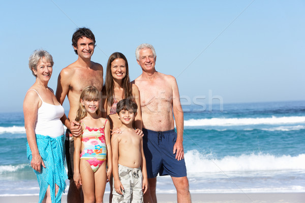 Three Generation Family On Holiday Walking Along Beach Stock photo © monkey_business