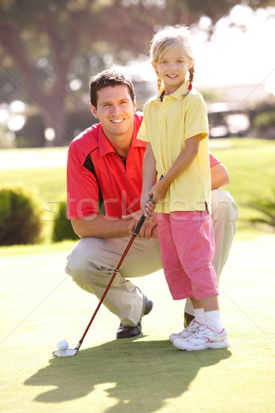 Padre insegnamento figlia giocare golf verde Foto d'archivio © monkey_business