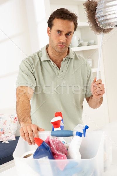 Bored Man Cleaning Light Fitting With Feather Duster Stock photo © monkey_business