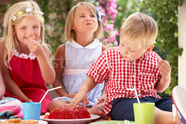 Group Of Children Eating Jelly At Outdoor Tea Party Stock photo © monkey_business