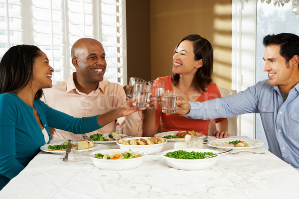 Groep vrienden genieten maaltijd home water Stockfoto © monkey_business