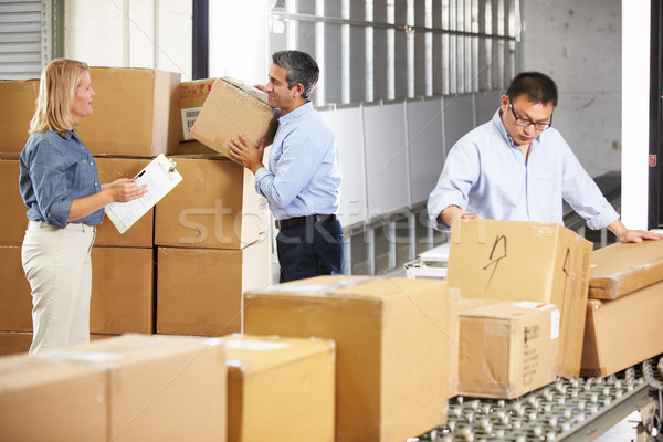 Workers Checking Goods On Belt In Distribution Warehouse Stock photo © monkey_business