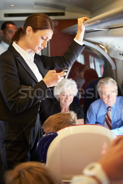 Kobieta interesu telefonu komórkowego zajęty podmiejskich pociągu kobieta Zdjęcia stock © monkey_business