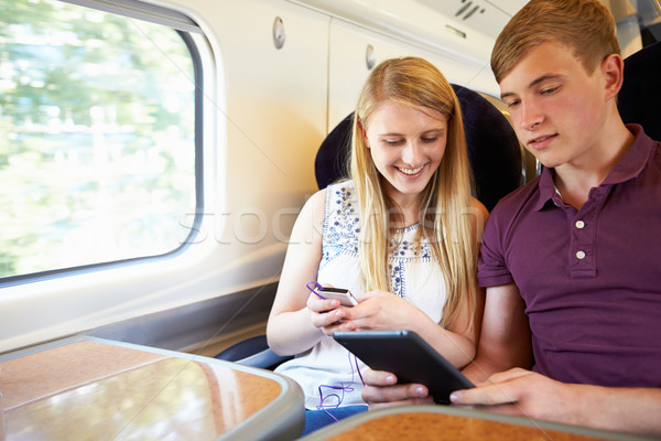 Fiatal pér olvas könyv vonat utazás férfi Stock fotó © monkey_business