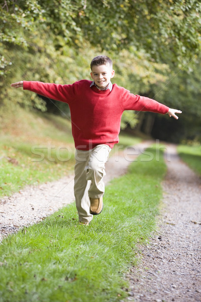 Young boy running along woodland path Stock photo © monkey_business