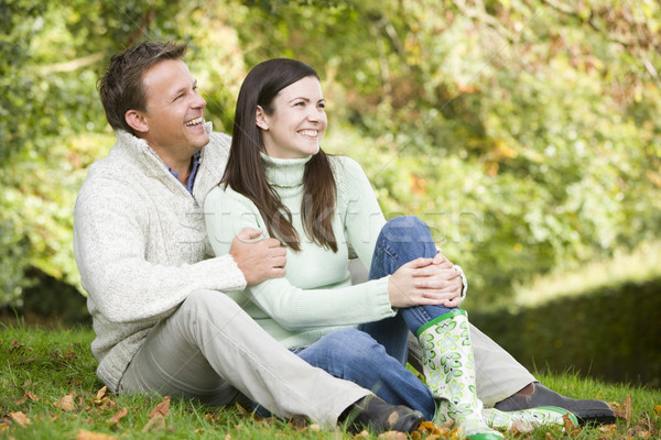 Young couple sitting in autumn woods Stock photo © monkey_business