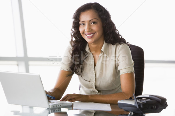 Businesswoman working at desk Stock photo © monkey_business
