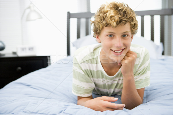 Tizenéves fiú ágy tini fiú lámpa hálószoba Stock fotó © monkey_business