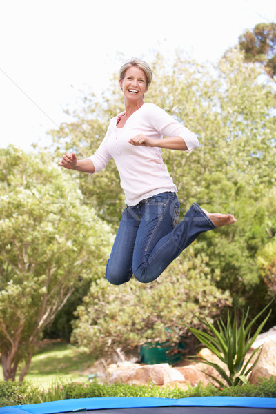 Mulher saltando trampolim jardim retrato pessoa Foto stock © monkey_business