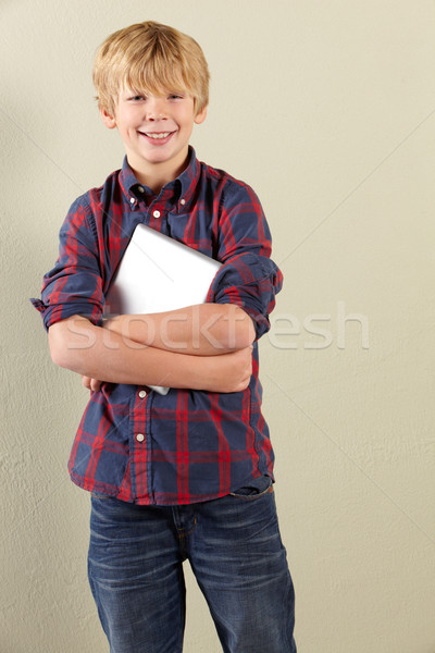Stock photo: Studio Shot Of Young Boy Holding Tablet Computer