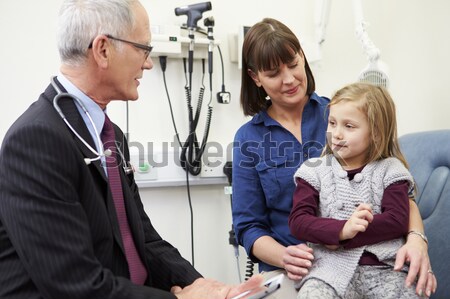 Stock photo: Teacher helping girl using computer in class