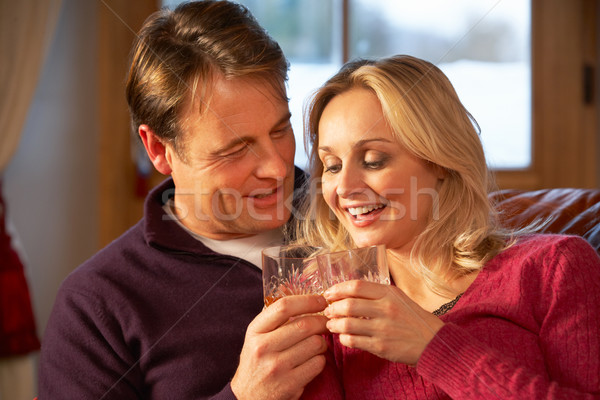 Middle Aged Couple Sitting On Sofa With Glasses Of Whisky Stock photo © monkey_business