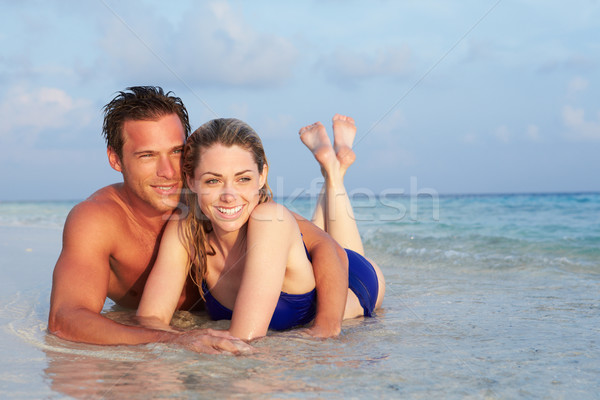 Romantic Couple Lying In Sea On Tropical Beach Holiday Stock photo © monkey_business