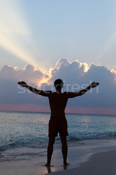 Silhouette Of Man With Outstretched Arms On Beach At Sunset Stock photo © monkey_business