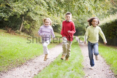 Mother and children running along woodland path Stock photo © monkey_business