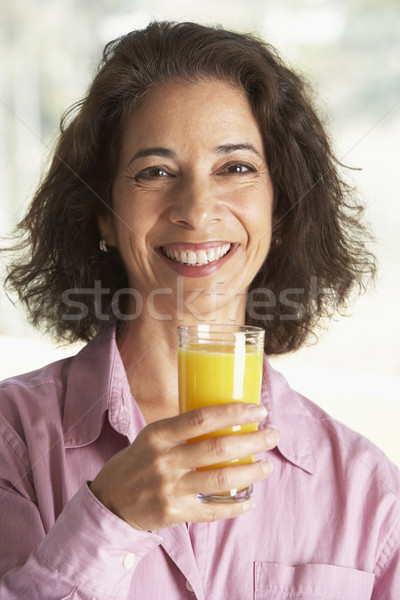 Middle Aged Woman Drinking Fresh Orange Juice Stock photo © monkey_business