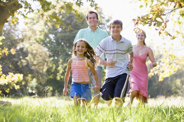 Family running outdoors smiling Stock photo © monkey_business