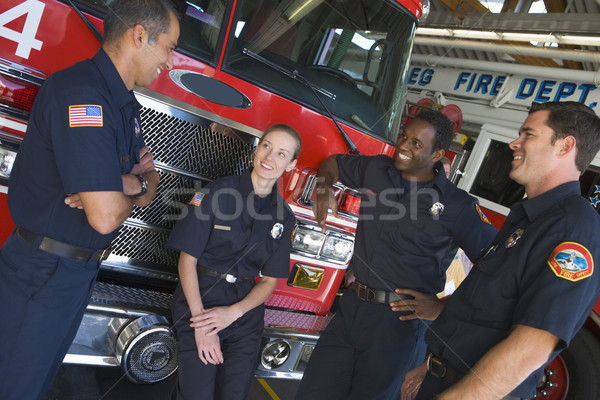 Stock photo: Firefighters chatting by a fire engine